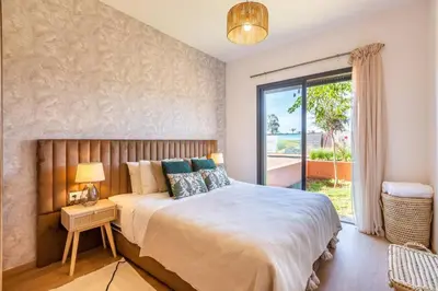 a bedroom with a large bed and a large window at Cute Place for Couple in Love - Pool in Marrakech