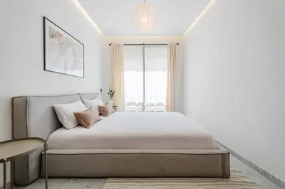 a bedroom with a bed and a window at Stylish and Central Downtown Retreat in Marrakech