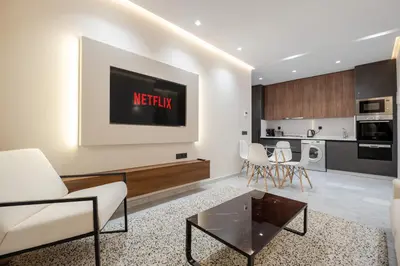 a living room with a tv on the wall at Stylish and Central Downtown Retreat in Marrakech