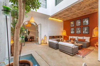 a living room with a couch and a table at Dar KAJAM -Privatized Riad -10mn from Jamaa Al Fna in Marrakech