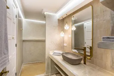 a bathroom with a sink and a mirror at Dar KAJAM -Privatized Riad -10mn from Jamaa Al Fna in Marrakech