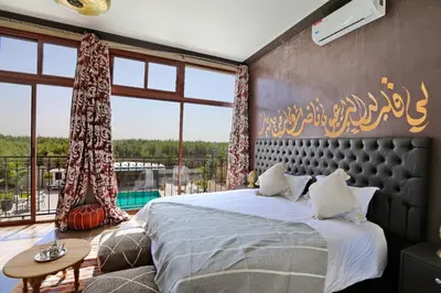 a bedroom with a bed and a large window at Villa Sahar in Marrakech