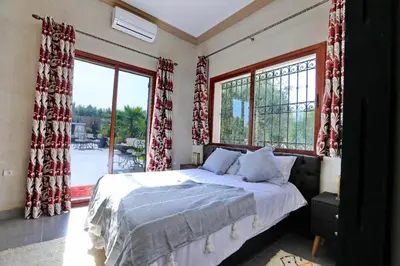 a bedroom with a bed and a large window at Villa Sahar in Marrakech