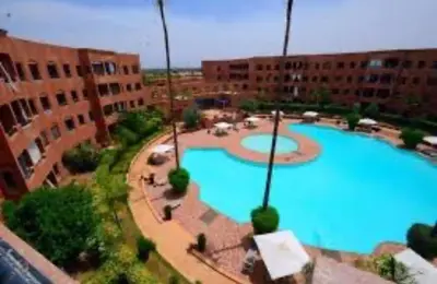 an overhead view of a large swimming pool in a city at Appartement meublé à River palm in Marrakech