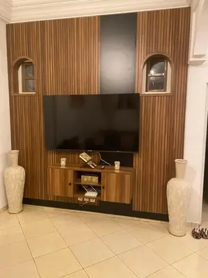 a large entertainment center with a flat screen tv at Apparemment tout confort in Marrakech