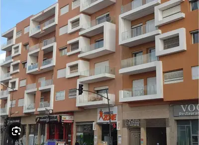 a tall building with balconies on the side of it at Center appartement Marrakech in Marrakech