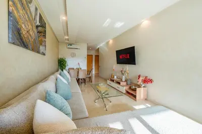 a living room with a couch and a table at Exceptional Golf Apartment - 2 Bedrooms Prestigia Marrakech in Marrakech