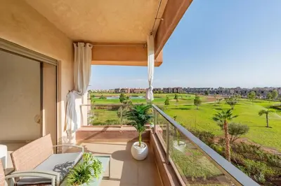 a balcony with a view of a green field at Exceptional Golf Apartment - 2 Bedrooms Prestigia Marrakech in Marrakech