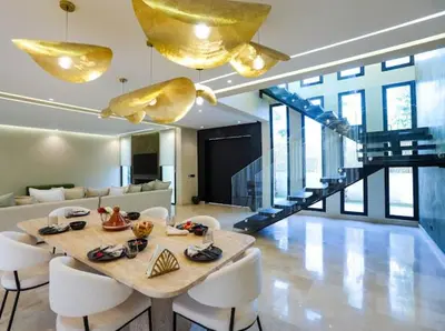 a dining room with a table and white chairs at VILLA Wa EXCLUSIVE MARRAKECH in Marrakech