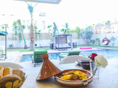 a table with a plate of food on top of it at VILLA Wa EXCLUSIVE MARRAKECH in Marrakech