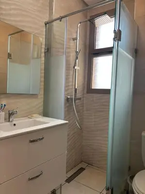 a bathroom with a shower and a sink at Jubaea youmna in Marrakech