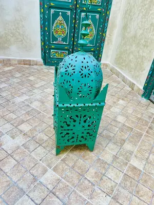 a green chair sitting on a tiled floor at Maison Cascada 2 in Marrakech
