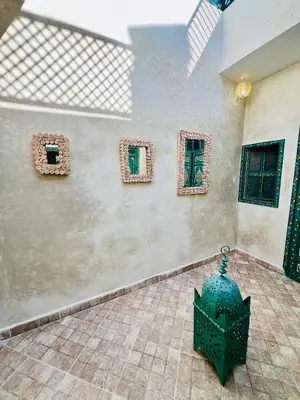 a room with four windows and a green object on a wall at Maison Cascada 2 in Marrakech
