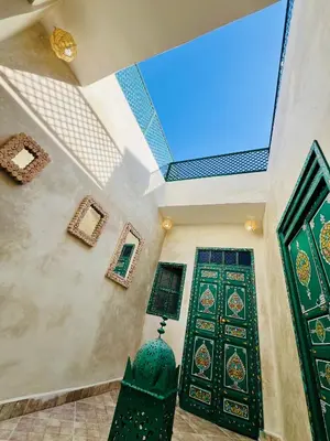a room with a large window and a door at Maison Cascada 2 in Marrakech