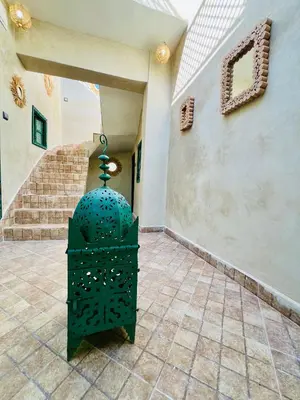 a green vase sitting in the middle of a hallway at Maison Cascada 2 in Marrakech