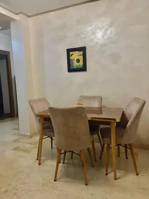 a dining room with a wooden table and chairs at Chic appartement marrakech in Marrakech
