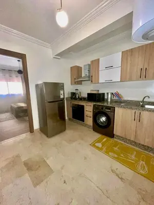 a kitchen with a stainless steel refrigerator and a dishwasher at Chic appartement marrakech in Marrakech
