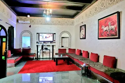 a living room with red couches and a flat screen tv at Gîte AYA in Marrakech