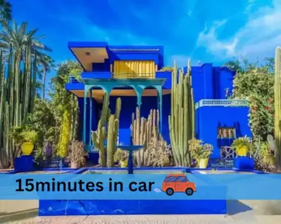 a blue house with a car in front of it at NATURALapartmentLARGE pool in Marrakech