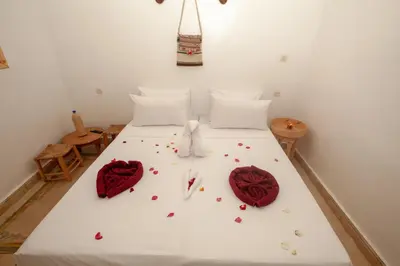 a bedroom with a bed with red roses on it at riad dar wlidati in Marrakech