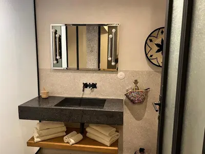 a bathroom with a sink and a mirror at Appartement Élégant et Spacieux Près de Carré Eden in Marrakech