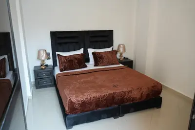 a bedroom with a large bed with two night stands at Bayt Al Atlas in Marrakech