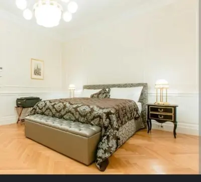 a bedroom with a bed and a table with a night stand at Maison lala in Marrakech