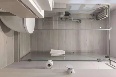 a bathroom with a glass shower with two rolls of toilet paper at Maison lala in Marrakech