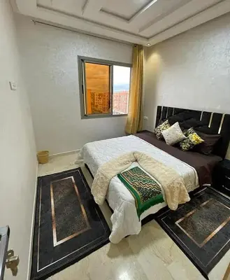 a bedroom with a large bed with a window at Maison lala in Marrakech