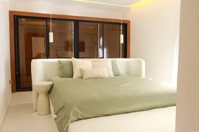 a white bed in a room with a window at Superbe Duplex piscine chauffée in Marrakech
