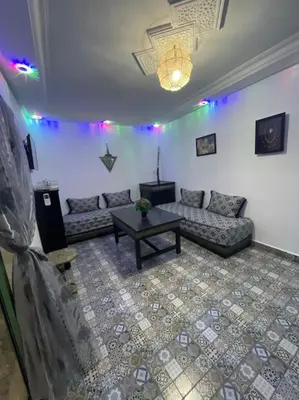 a living room with a couch and a table at Gîte Familial Aïcha in El Gouassem