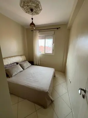 a small bedroom with a bed and a window at Location Familiale Marrakech 2 in Marrakech