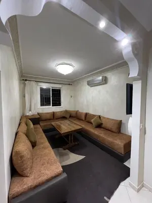 a living room with a couch and a table at Location Familiale Marrakech 2 in Marrakech