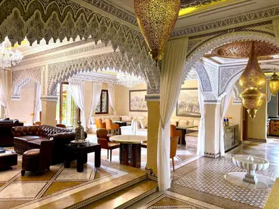 a living room with a couch and tables and chairs at Palais Mars in Marrakech