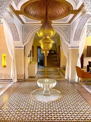 a large room with a fountain in the middle of a building at Palais Mars in Marrakech