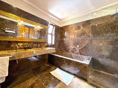 a bathroom with a tub and a sink at Palais Mars in Marrakech
