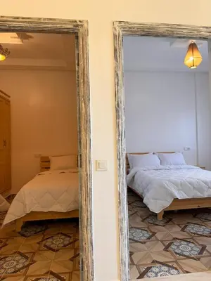 a mirror reflection of a bed in a bedroom at cosy appartement a marrakech in Marrakech