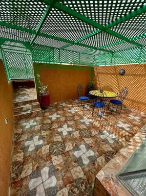 a patio with a table and chairs in a building at Riad mostafa in Marrakech