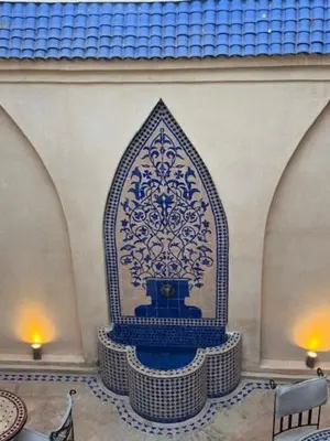 a blue and white fountain in a room at Riad Lou Kasbah in Marrakech