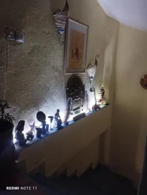 a room with a fireplace with figurines on a shelf at Chez Joe Dassin in Aït Bou Setta