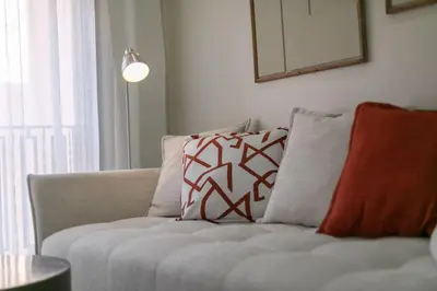 a couch with pillows on it in a living room at Chic urbain en plein centre in Marrakech