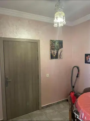 a room with a door and a table and a chandelier at Appart in Marrakech 5G in Marrakech