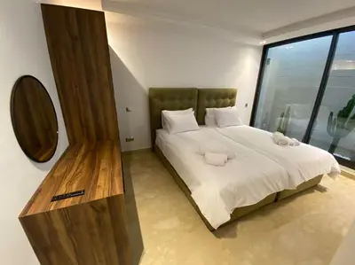 a bedroom with a large bed with a large window at Sublime Villa avec Ascenseur Piscine chauffée in Marrakech
