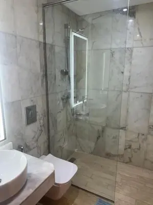 a bathroom with a shower and a toilet and a sink at Sublime Villa avec Ascenseur Piscine chauffée in Marrakech
