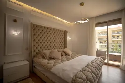 a bedroom with a large bed with a large window at Bonjour cher client in Marrakech