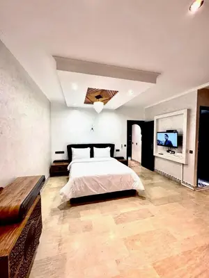 a bedroom with a bed and a flat screen tv at Medley Luxury Villa - PARKING, WIFI & PISCINE in Marrakech