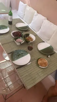 a table with plates and bowls of food on a couch at Le RIAD Paradis Secret in Marrakech
