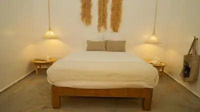 a bed in a room with two tables and two lamps at Le RIAD Paradis Secret in Marrakech