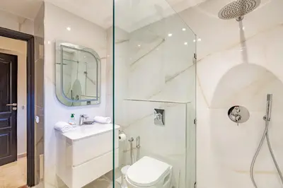a bathroom with a shower and a toilet and a sink at Coup de coeur en plein centre ville piscine in Marrakech