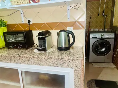 a kitchen counter with a microwave and a coffee maker at Cozy Studio center of Marrakech in Marrakech